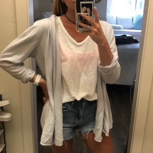 Light purple-ish, light blue-ish cardigan.